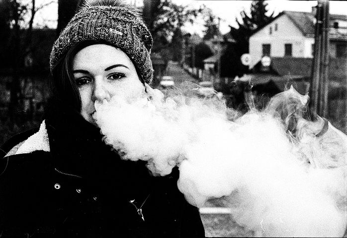 woman with smoke in her mouth